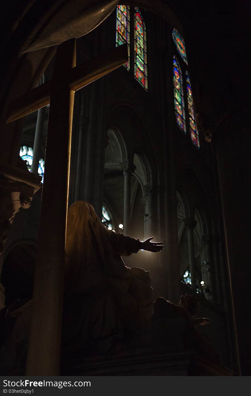 Silhouetted statue inside Notre Dame de Paris. Silhouetted statue inside Notre Dame de Paris