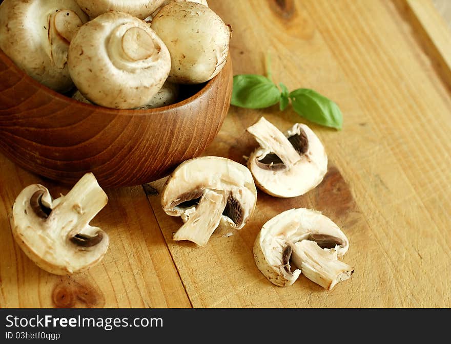 Fresh mushrooms in wooden bowl