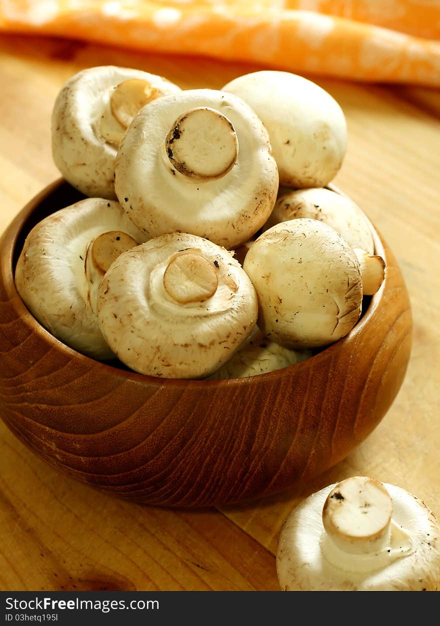 Fresh mushrooms in wooden bowl