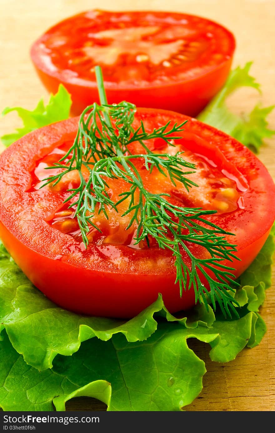 A red tomato on the wooden table