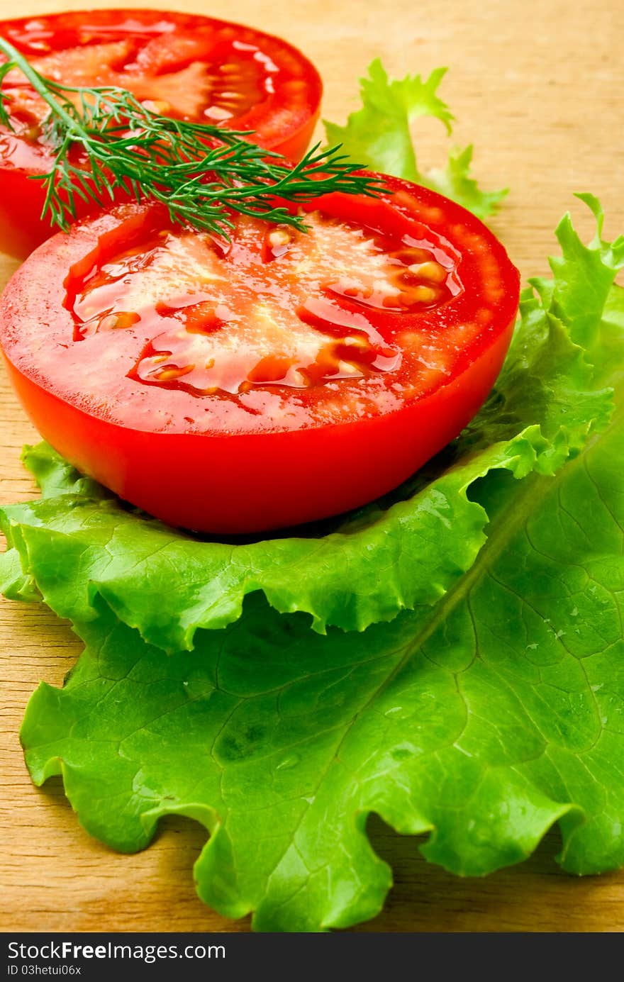 A red tomato on the wooden table