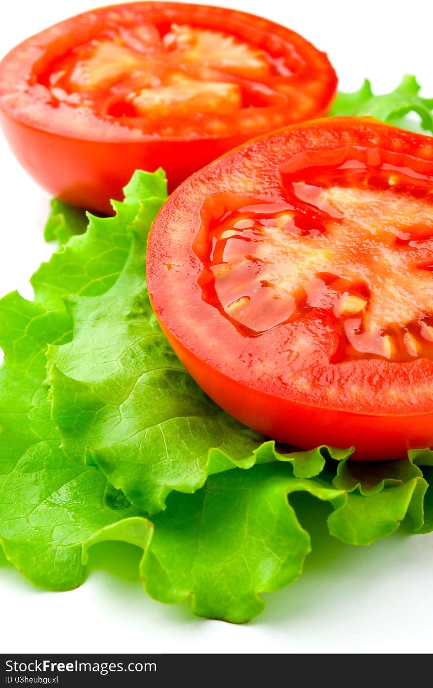 Red tomatoes and lettuce on a white background