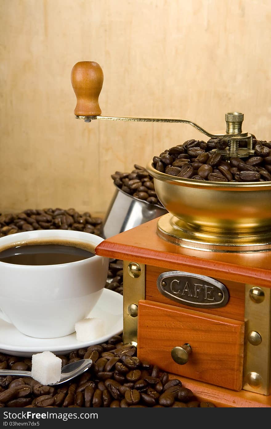 Coffee Beans, Cup And Grinder On Wood