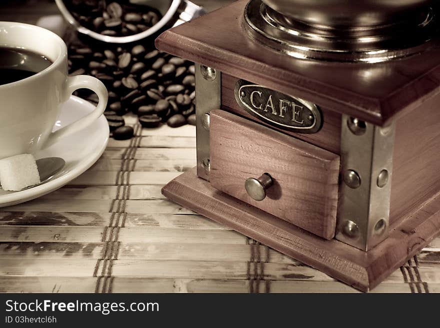 Cup of coffee, pot with beans and grinder on vintage. Cup of coffee, pot with beans and grinder on vintage