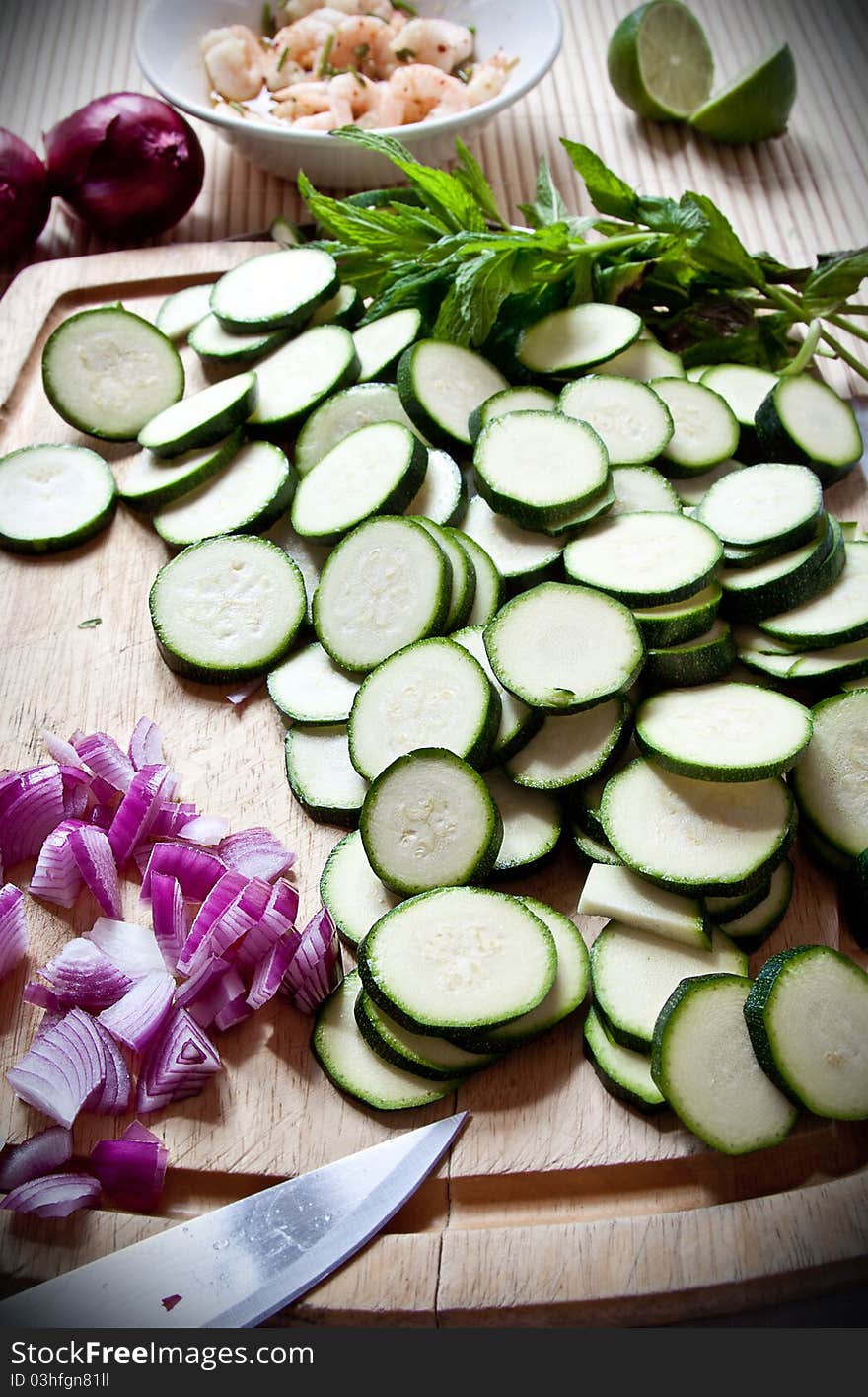 Food preparation: courgettes and onions on a board