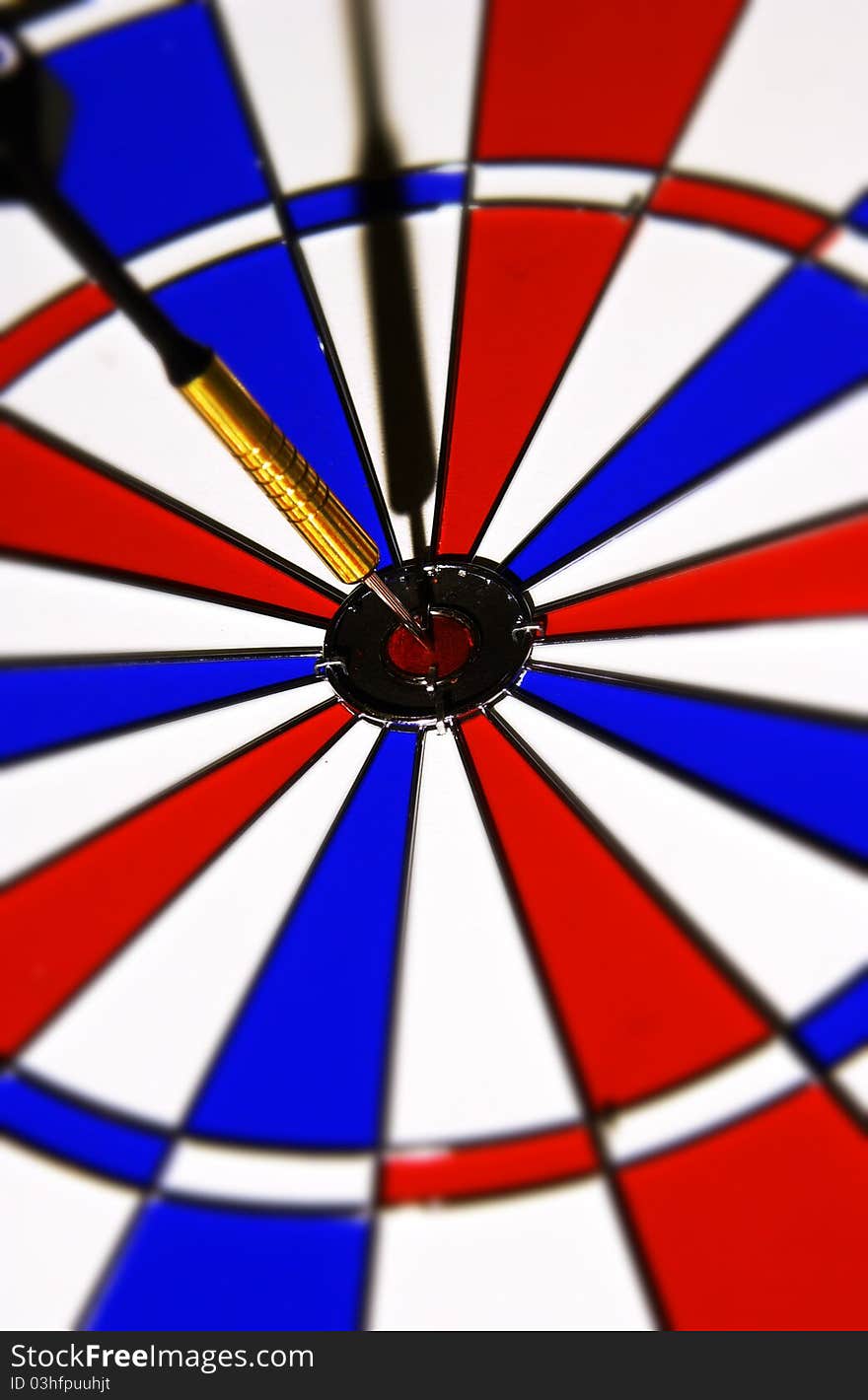 Close up of dart in center of dartboard