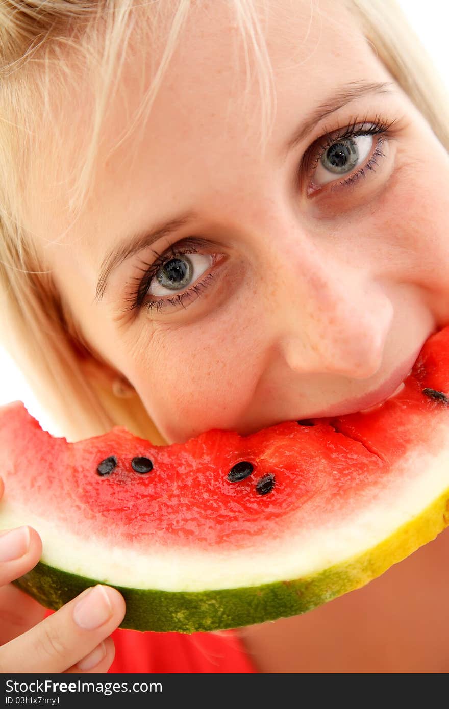 Closeup of a young girl eating watermelon