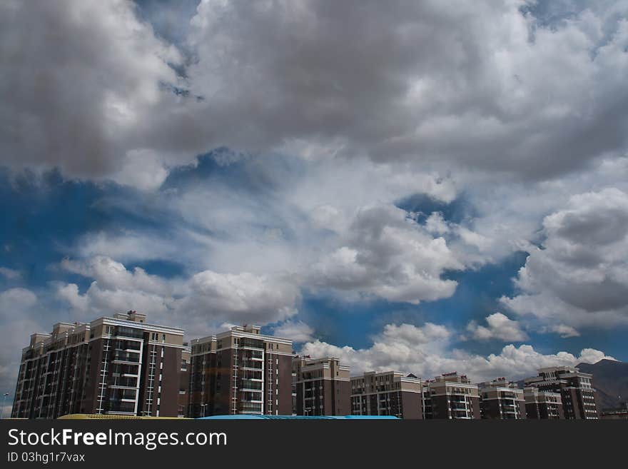 The sky above the beautiful residential buildings. Sa afternoon with the air inviting passion. The sky above the beautiful residential buildings. Sa afternoon with the air inviting passion.