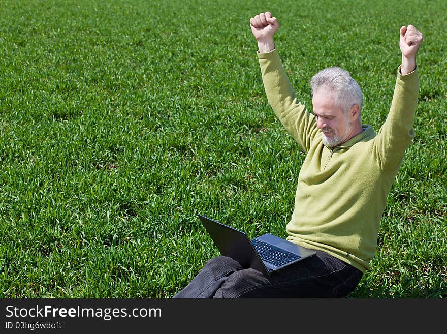 Exciting grandfather with a laptop