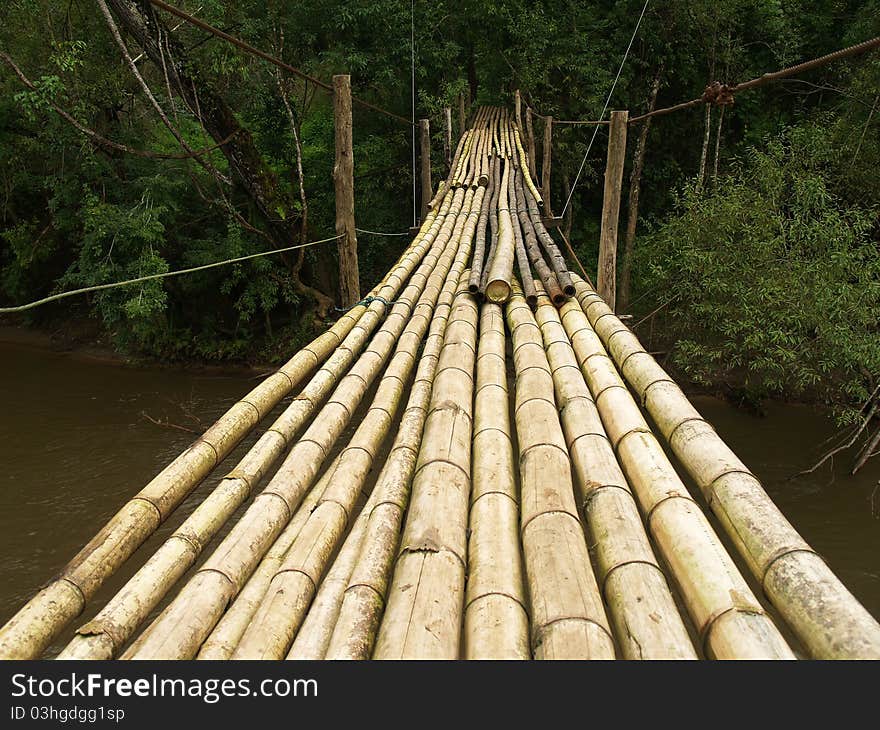 Hanging bamboo bridge over river