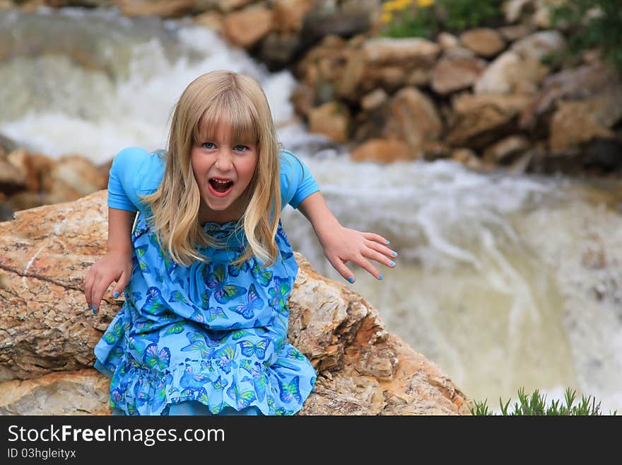 Cute young girl pulls a scary funny face