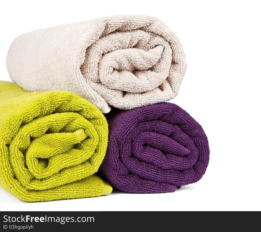 Rolled up colorful towels isolated on white