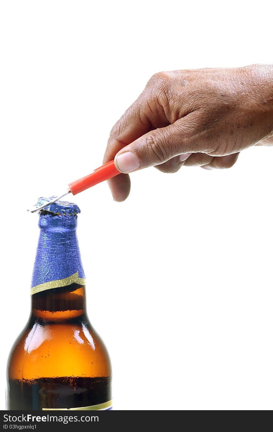 Male hand opening beer bottle with opener.