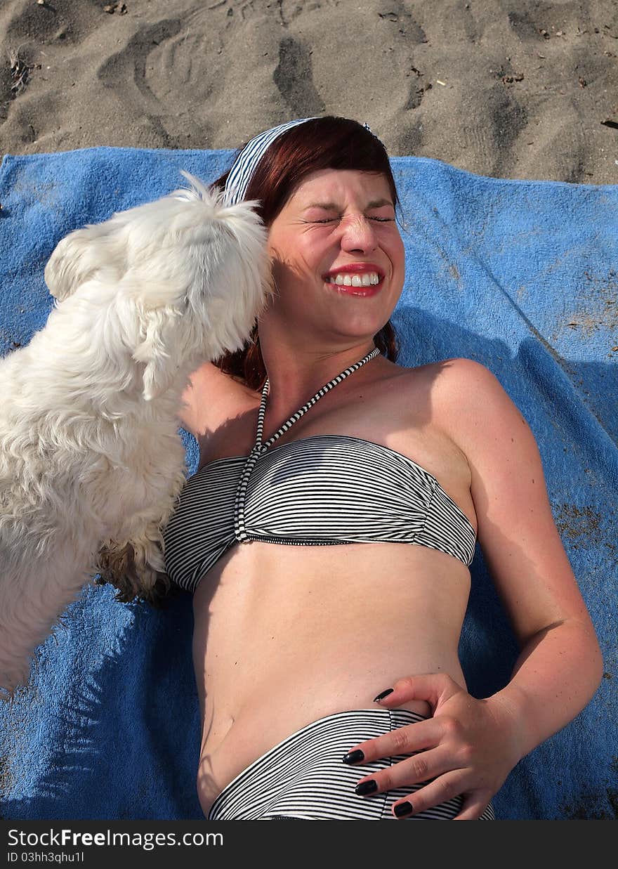 Retro girl having fun with her dog at the beach. Retro girl having fun with her dog at the beach