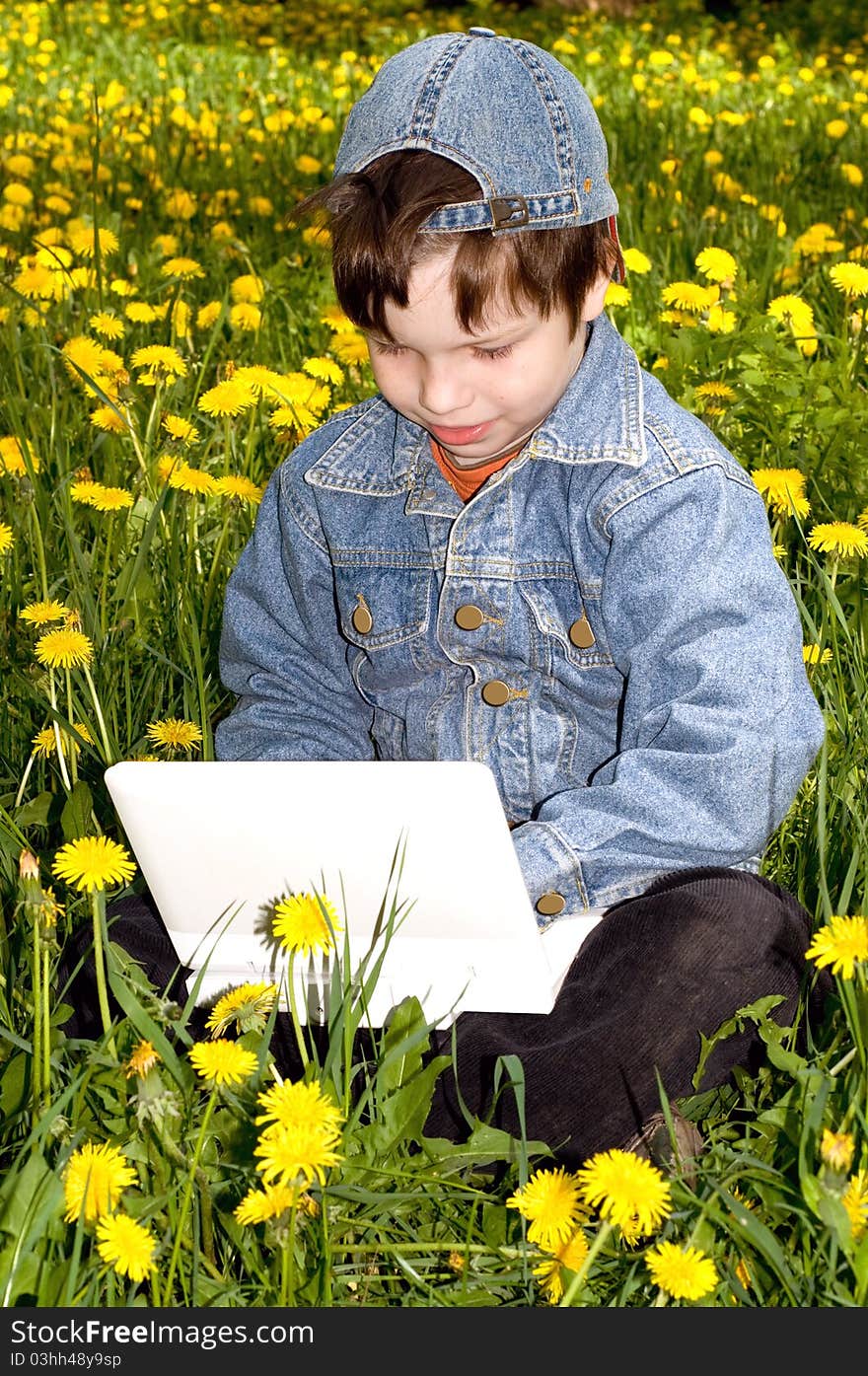 In the photo presented the boy with the netbooks on the nature. In the photo presented the boy with the netbooks on the nature