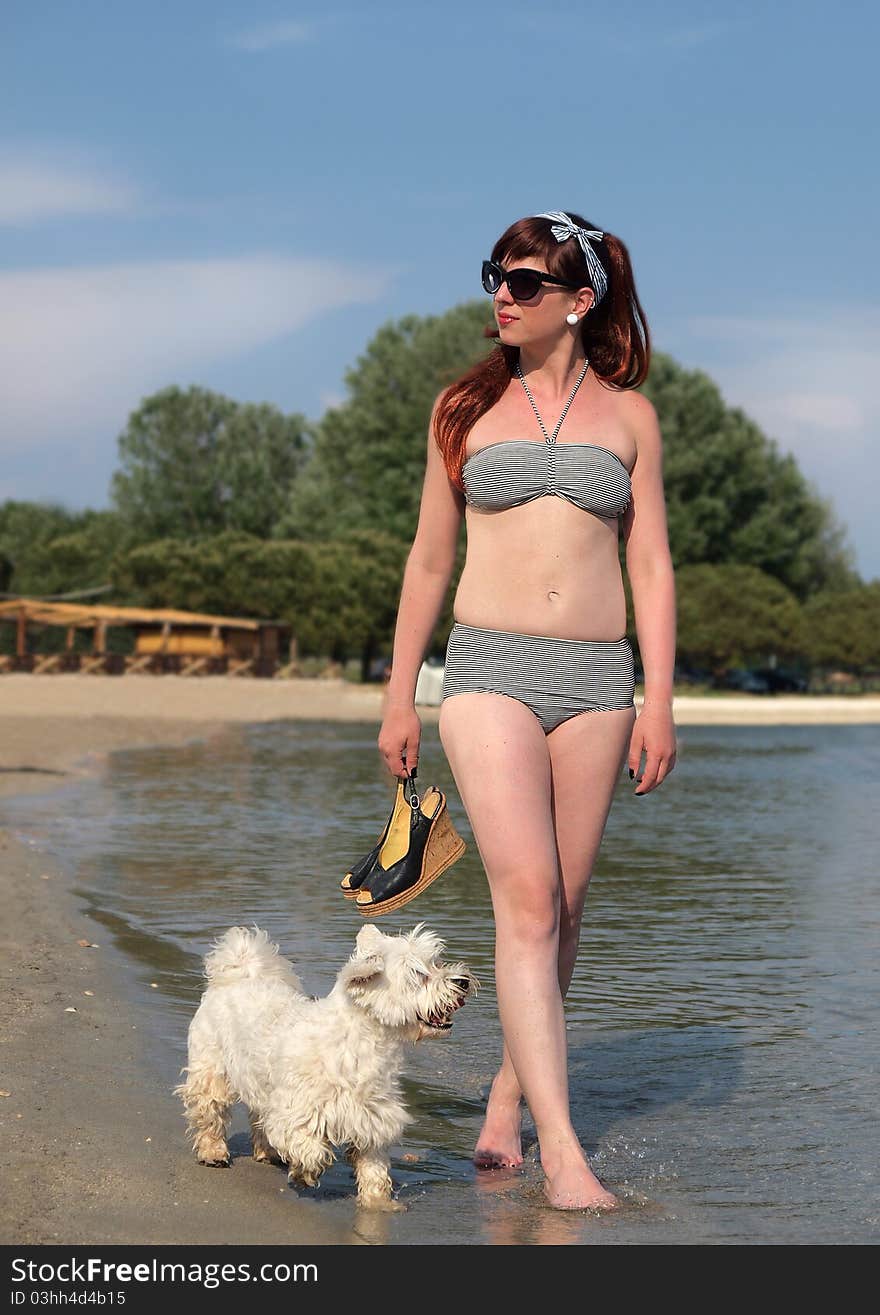 Retro girl having fun with her dog at the beach. Retro girl having fun with her dog at the beach