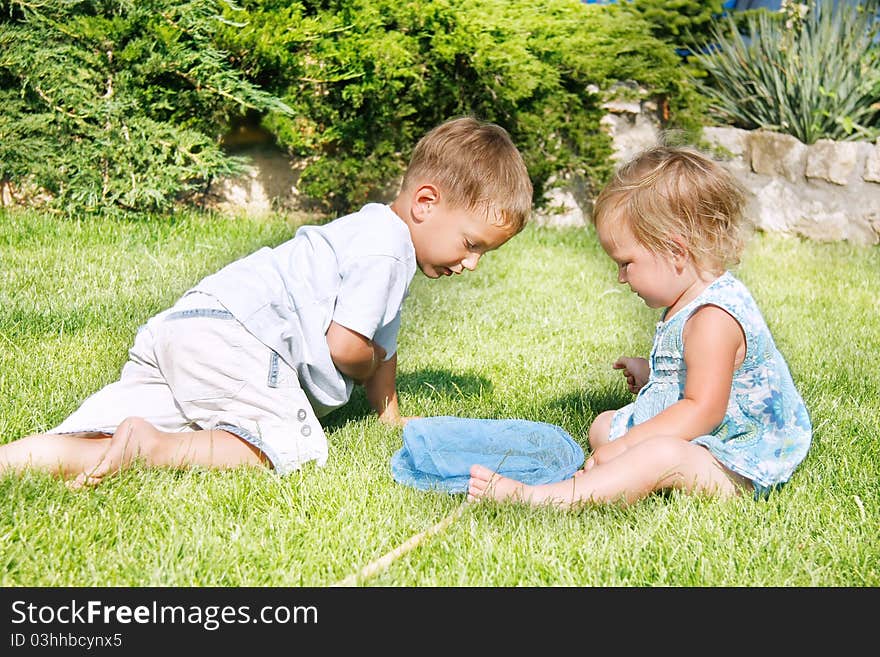 Two children playing on grass. Two children playing on grass