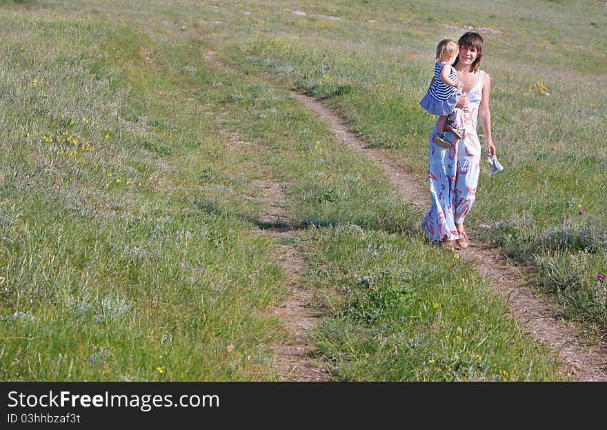 Mother and child walking by road