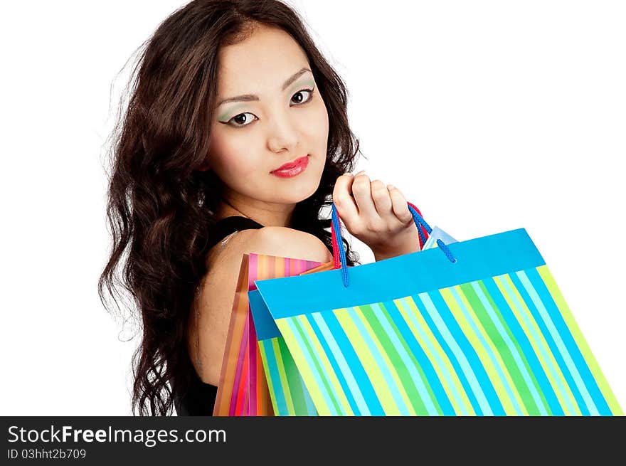 Asiatic young women  with shopping bags, isolated on white, close-up. Asiatic young women  with shopping bags, isolated on white, close-up