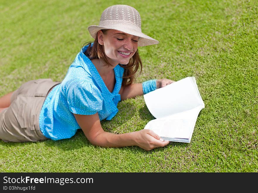 Happy woman with toothy smile lying down on a meadow. Happy woman with toothy smile lying down on a meadow