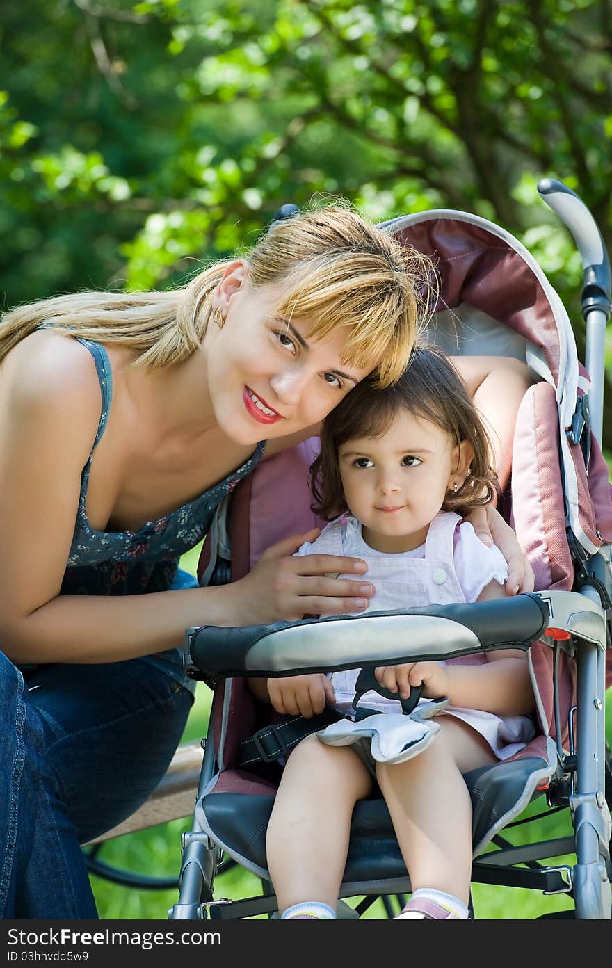 Mother with baby carriage in park