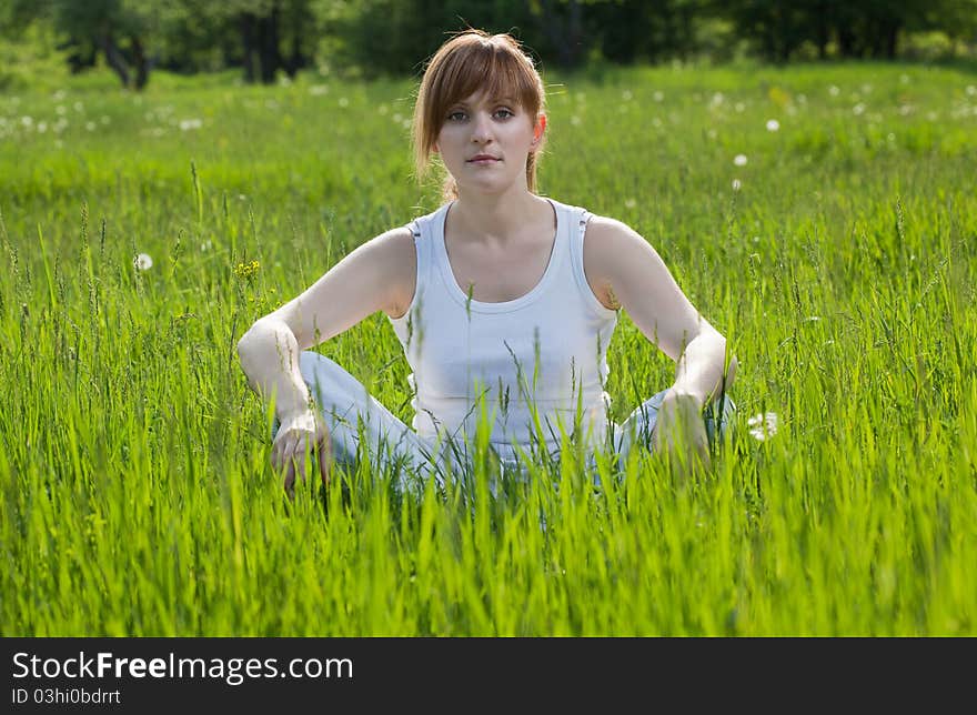 Girl In A Lotus Position In Park