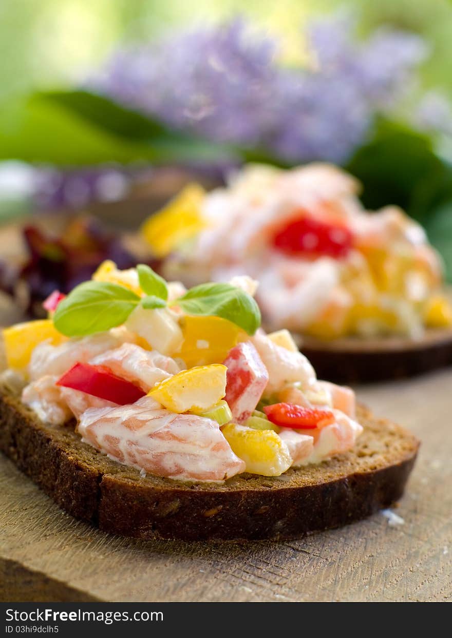 Bread with salad of salmon and vegetables. Selective focus