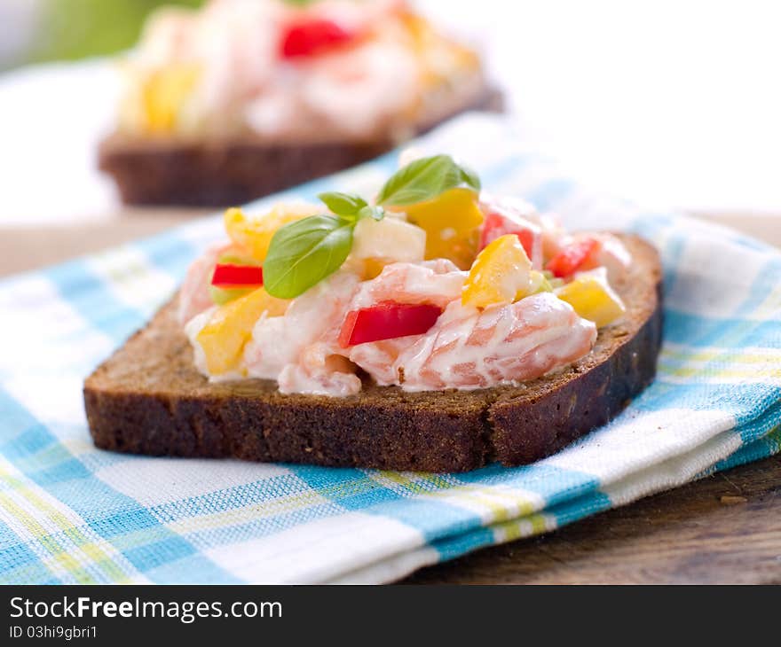 Bread with salad of salmon and vegetables. Selective focus