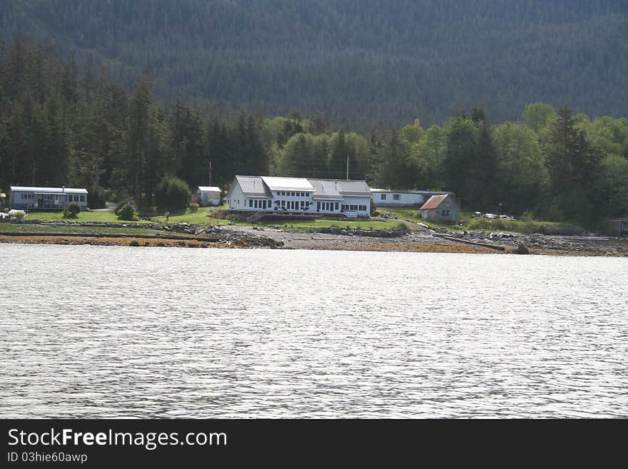 Large home on the beach in Southeastern Alaska with the Tongass National Forest in the background. Large home on the beach in Southeastern Alaska with the Tongass National Forest in the background.