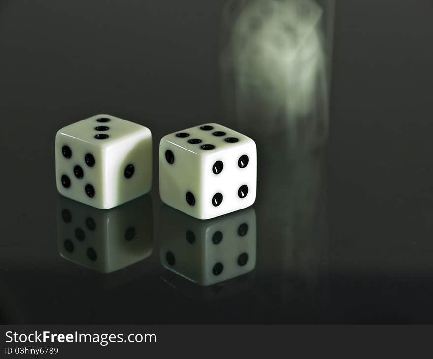 Two white dice and one is dicing