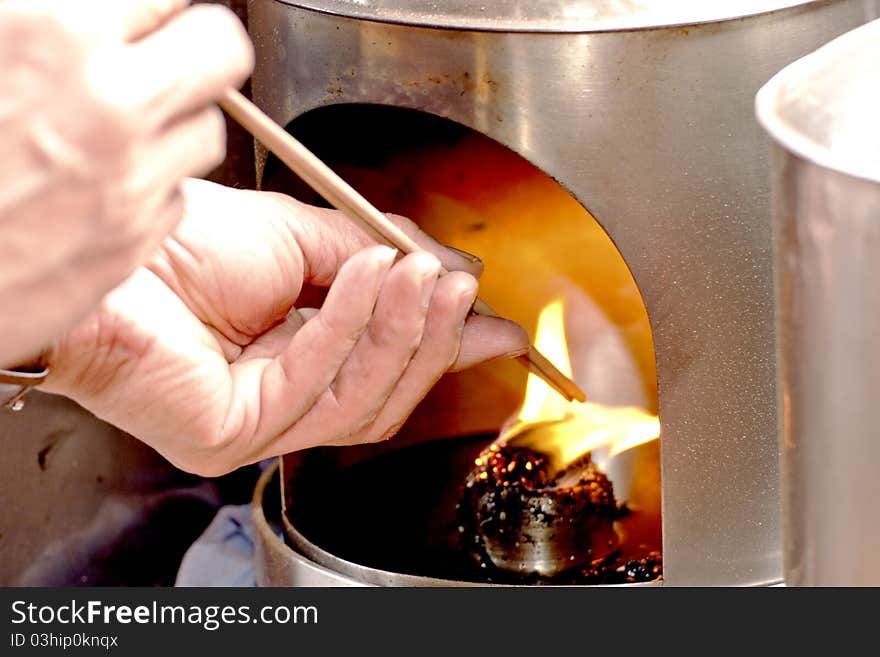 Burn joss sticks on fire