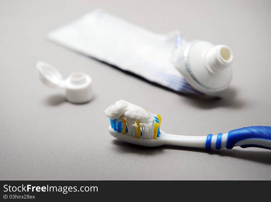 A closeup of a tooth brush with toothpaste.