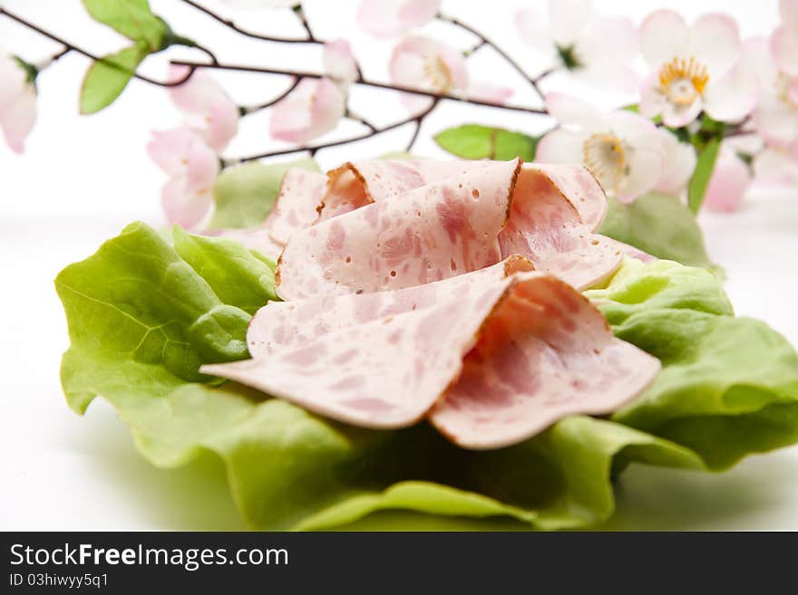 Ham sausage on lettuce leaf