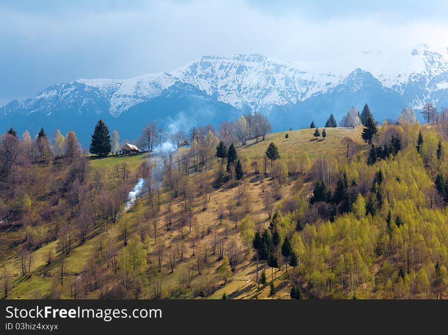 Spring landscape with mountains having snow and green trees on the hills. Spring landscape with mountains having snow and green trees on the hills