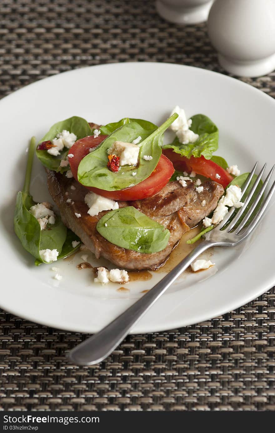 Steak with tomatoes, spinach and feta cheese