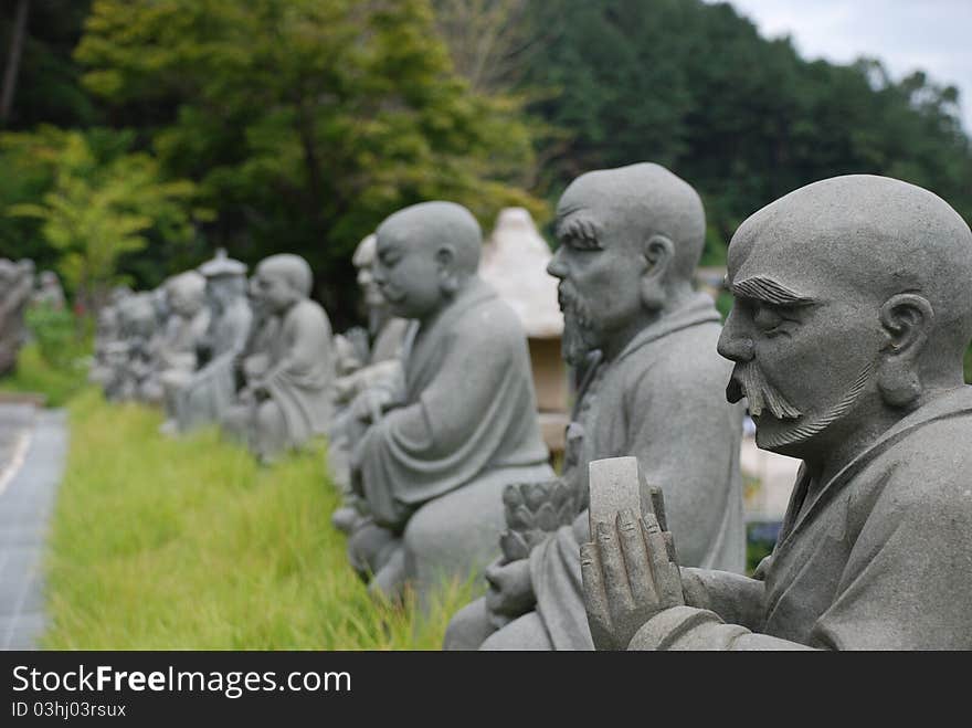 Buddhist Statues in a row at an Asian temple.