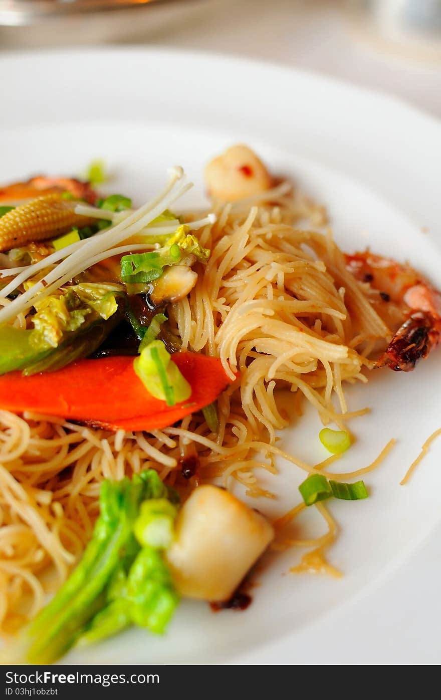 Elaborate Asian style dry vermicelli prepared with healthy vegetable and seafood ingredients. Elaborate Asian style dry vermicelli prepared with healthy vegetable and seafood ingredients.