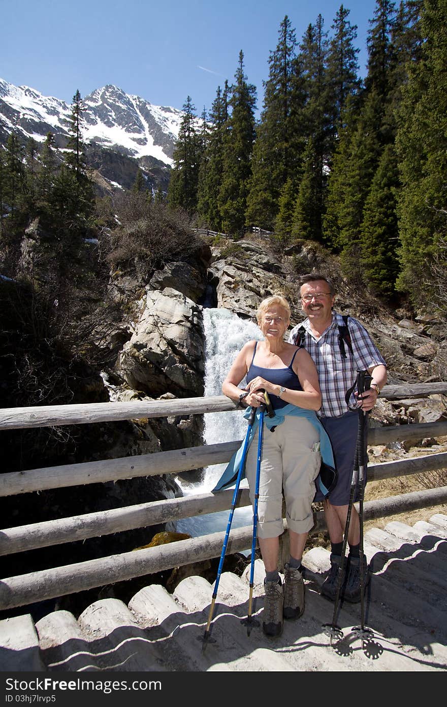 Retired couple hiking in the alps