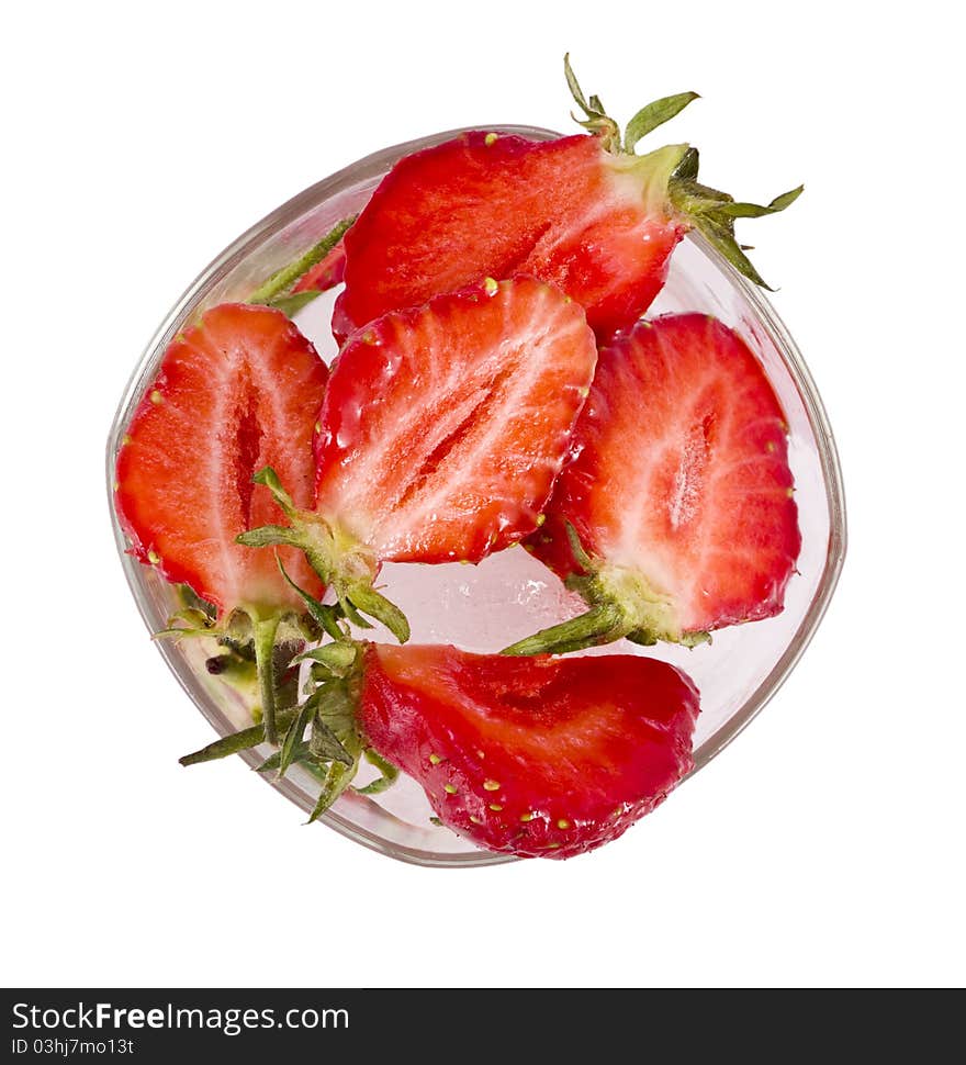 Strawberry by lobules in glass with ice. Strawberry by lobules in glass with ice