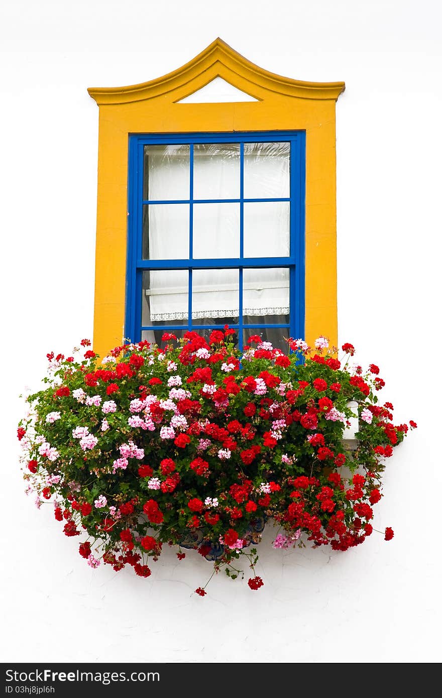 Traditional window with bright colors yellow and blue with many colorful red flowers. Traditional window with bright colors yellow and blue with many colorful red flowers