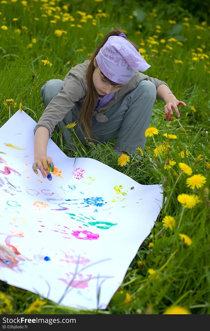 Child painting with paints on the meadow. Child painting with paints on the meadow