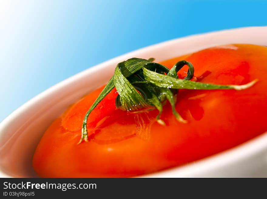 Fresh tomato in white cup