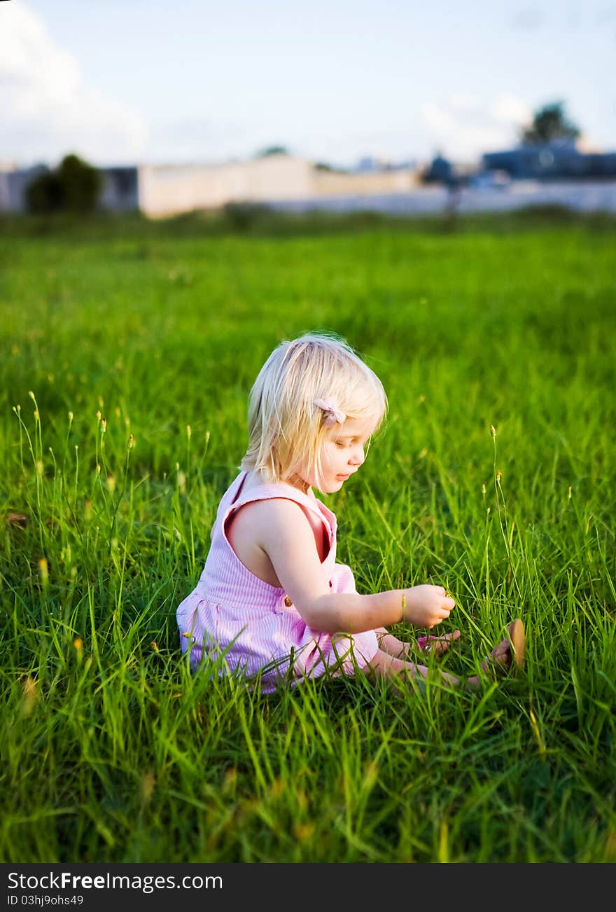 A little girl playing in the grass