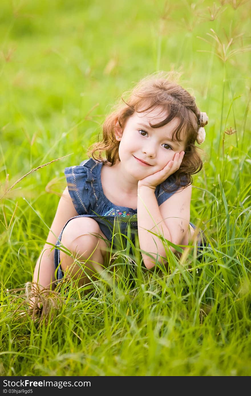 A beautiful young girl in a field of long grass