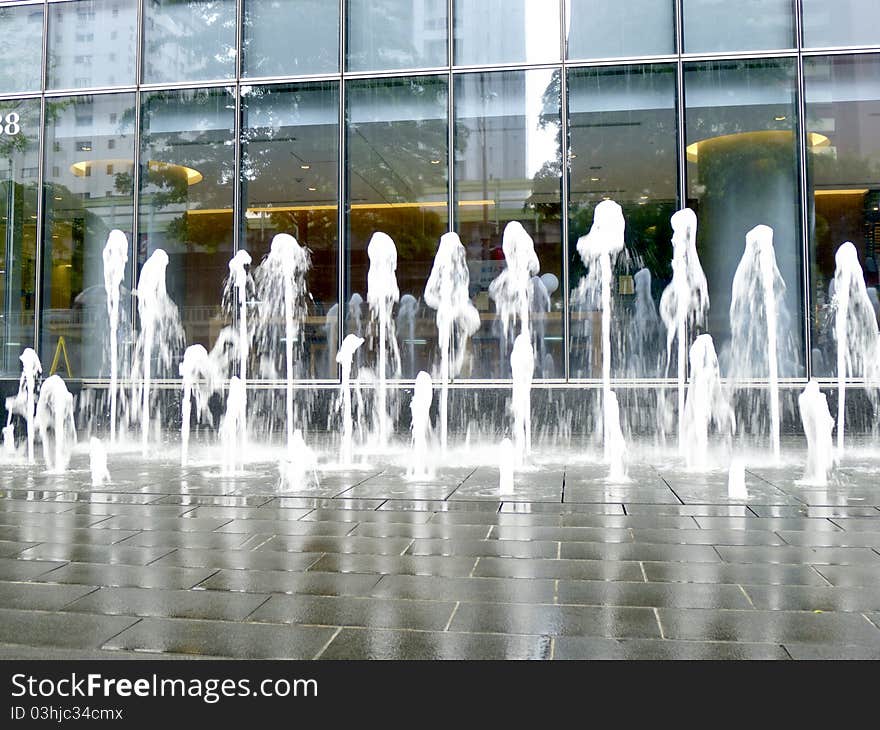 Fountains in front of a building in city. Fountains in front of a building in city