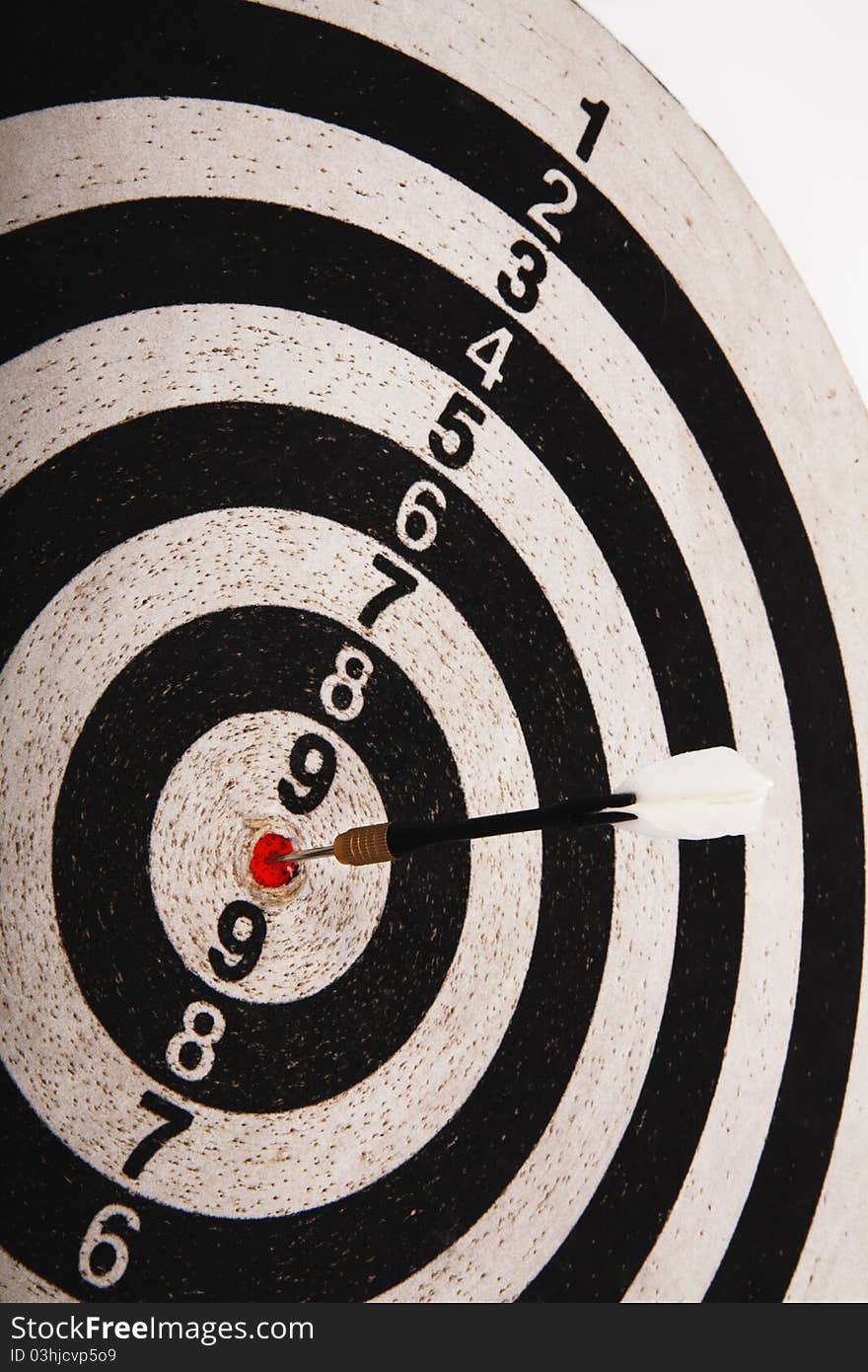 Closeup of dartboard target and dart arrow