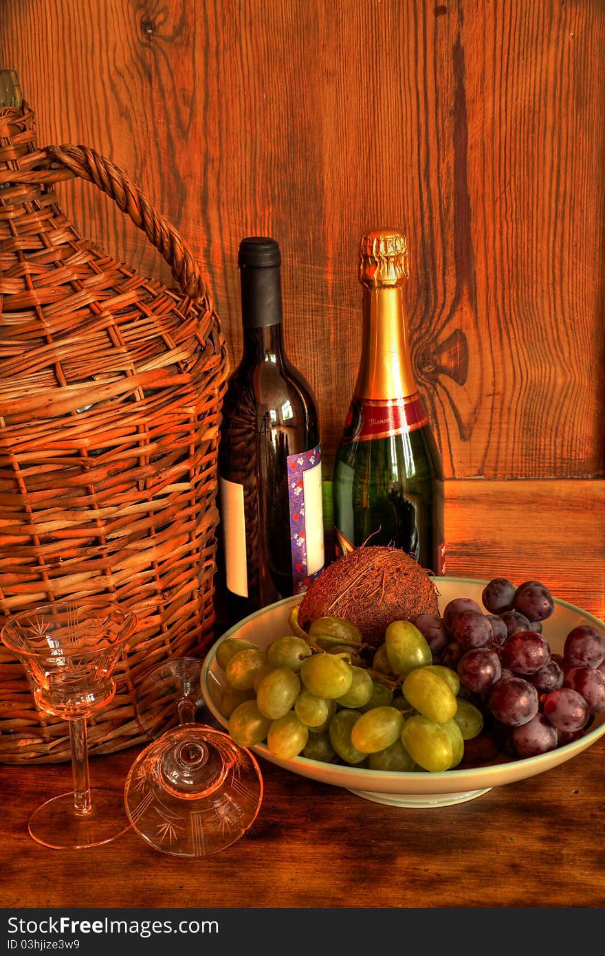 Glasses and grapes, bottles of wine and wooden background. Glasses and grapes, bottles of wine and wooden background.