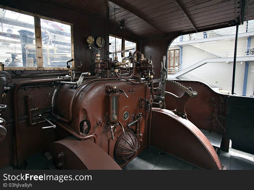 Closeup of vintage steam engine's black, iron wheel. Closeup of vintage steam engine's black, iron wheel