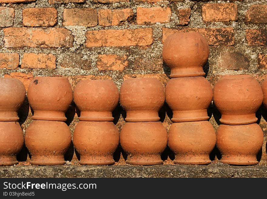 Ceramic pots against a brick wall