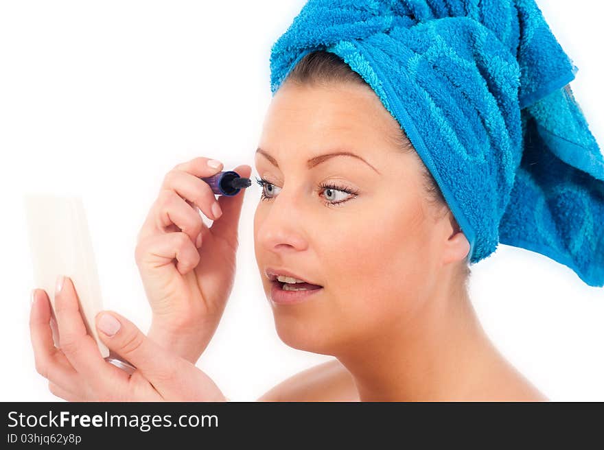 Young woman applying makeup